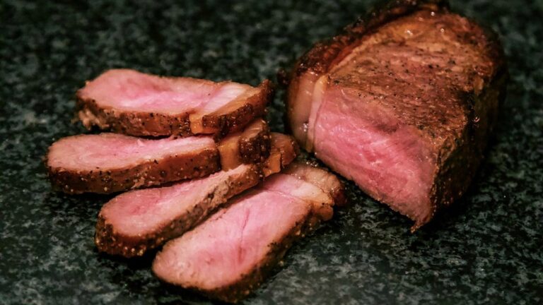Silent Medicine — sliced grass-fed beef on a dark stone surface, gentle light.