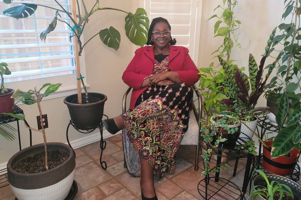 Dr. Nnenna Ndika in a calm, plant-filled space — warm, welcoming setting.