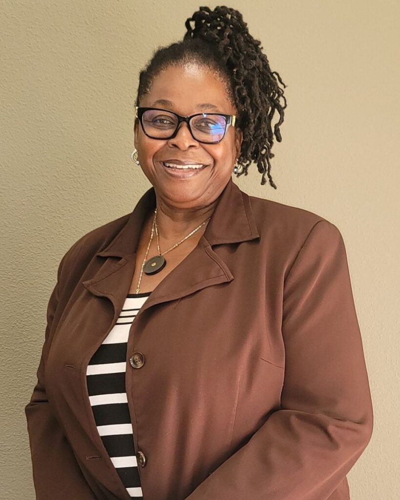 Portrait of Dr. Nnenna Ndika... calm, Afrocentric woman, who is professional yet warm.