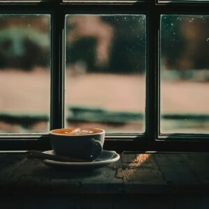 A warm cup by a window at dawn, inviting quiet breath and stillness to set the day’s tone.