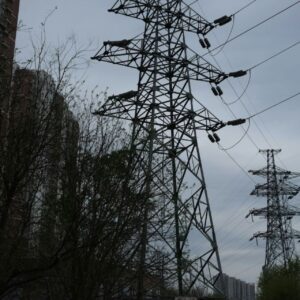 Power transmission towers and lines against an overcast sky, giving context for electrical environments.