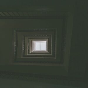 Looking from inside to the outside through a distant window, evoking a sense of disconnection and inner tension.