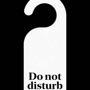 Black-and-white door hanger that reads “Do not disturb,” a cue to pause notifications and protect focus.