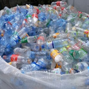 Pile of empty single-use plastic water bottles in a bag, illustrating disposables and potential leaching with heat/time.