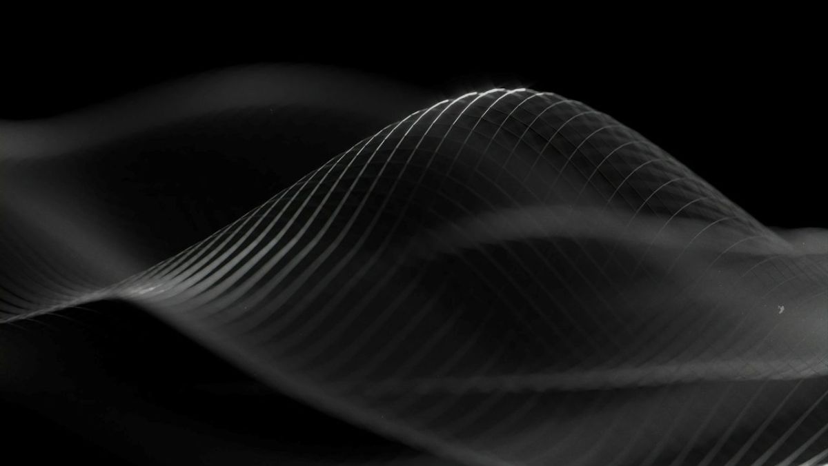 Monochrome wave lines on a black background, suggesting sound resonance and calm through humming
