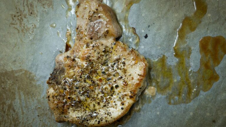Browned chicken or turkey patty resting on parchment after searing in tallow