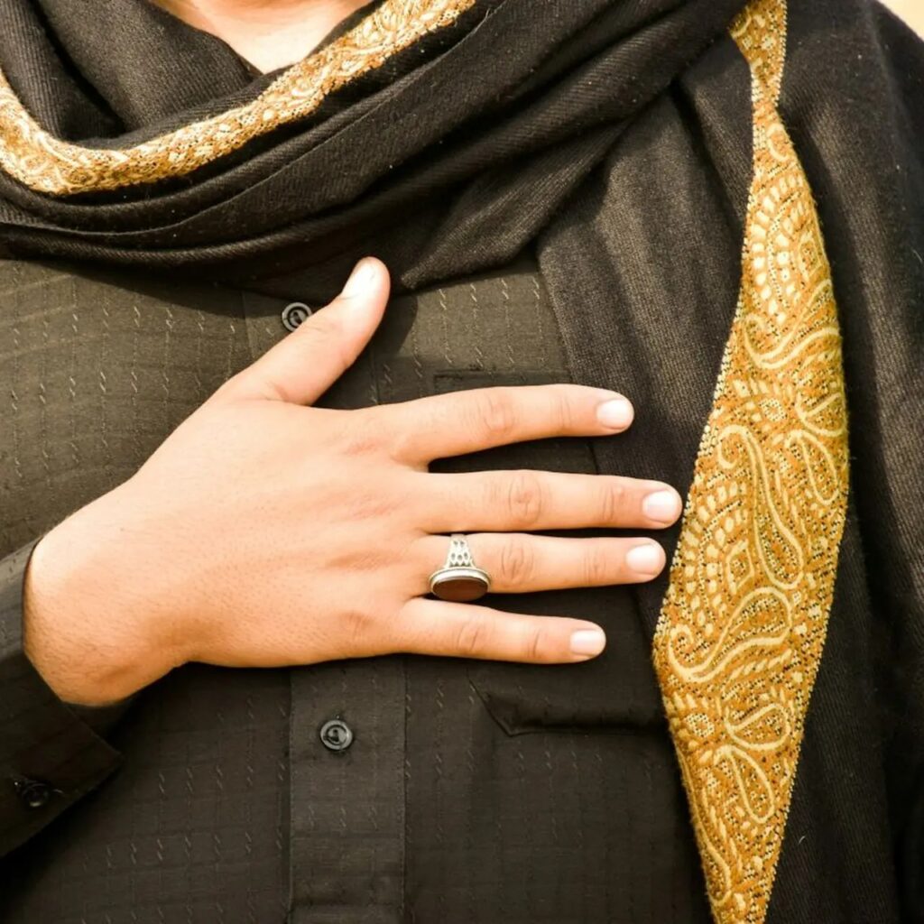 Hand resting over chest during slow exhale in warm light.