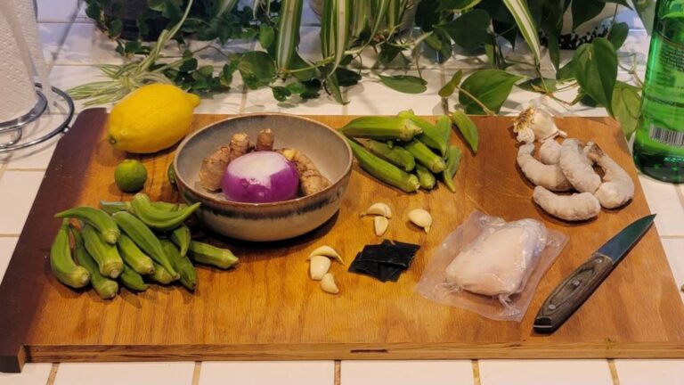 Bowl of okra chicken and cod mineral soup with shrimp, herbs, and rich broth
