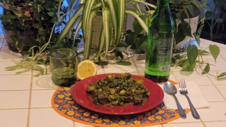 Hearty beef heart with okra and leafy greens served in a plant-filled healing environment
